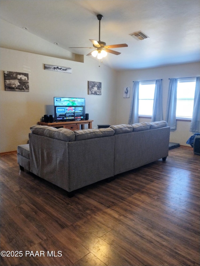 living room featuring dark wood-type flooring, ceiling fan, and lofted ceiling