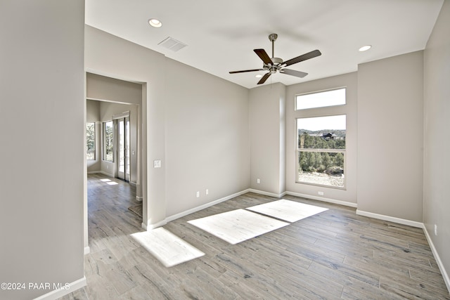 spare room featuring recessed lighting, a ceiling fan, visible vents, baseboards, and wood finished floors