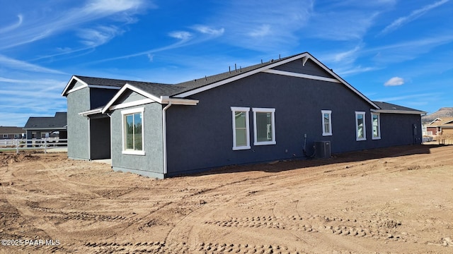 2485 Dillon Blvd, Chino Valley, AZ 86323 - view of side of property featuring stucco siding, central AC, and fence