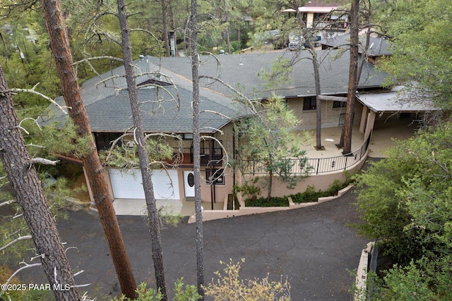 4937 S Deer Trl, Prescott, AZ 86303 - view of property exterior with roof with shingles, asphalt driveway, and brick siding