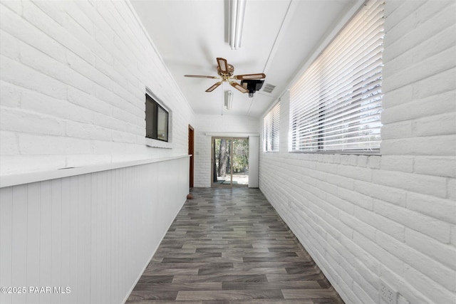 4937 S Deer Trl, Prescott, AZ 86303 - corridor with dark wood-type flooring and brick wall