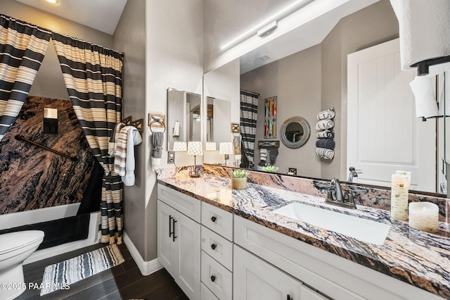 full bathroom with shower / bathtub combination with curtain, vanity, and toilet