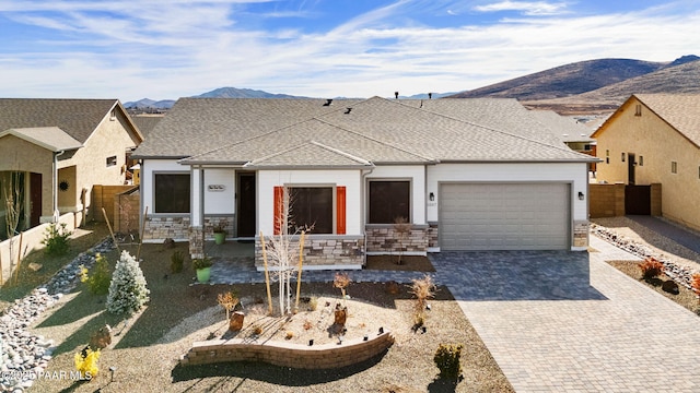 view of front facade featuring a garage and a mountain view