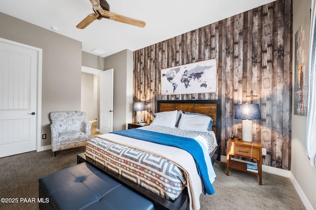 bedroom featuring ceiling fan, carpet, and wooden walls