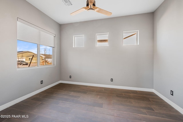 empty room with dark hardwood / wood-style floors and ceiling fan