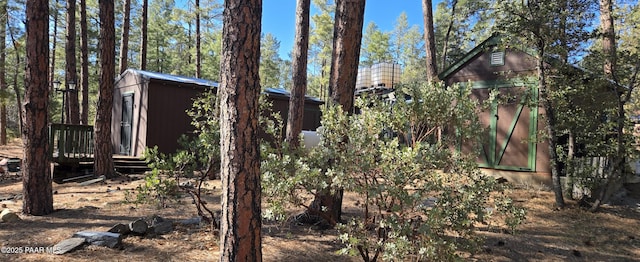 view of side of home featuring an outbuilding