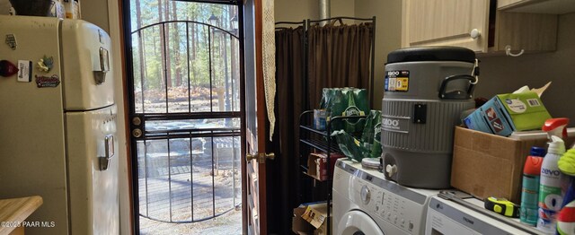 interior space featuring cabinet space and washing machine and dryer