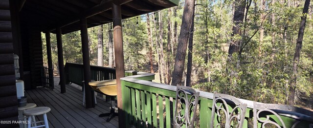 wooden terrace with a view of trees