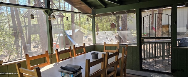 sunroom featuring lofted ceiling and a deck