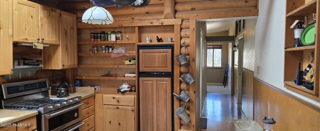 kitchen featuring rustic walls, light countertops, open shelves, and double oven range