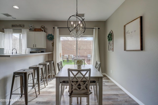 dining area featuring a chandelier and light hardwood / wood-style floors