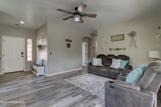 living room with light hardwood / wood-style flooring and ceiling fan