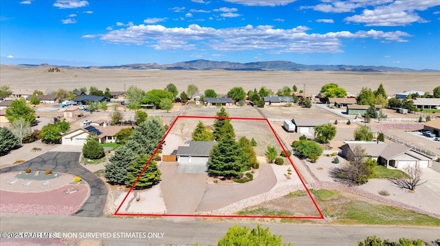 drone / aerial view featuring a residential view and a mountain view
