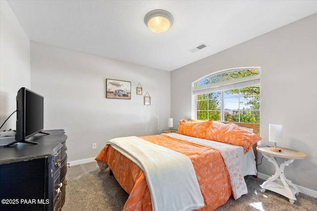 bedroom featuring baseboards, visible vents, and carpet