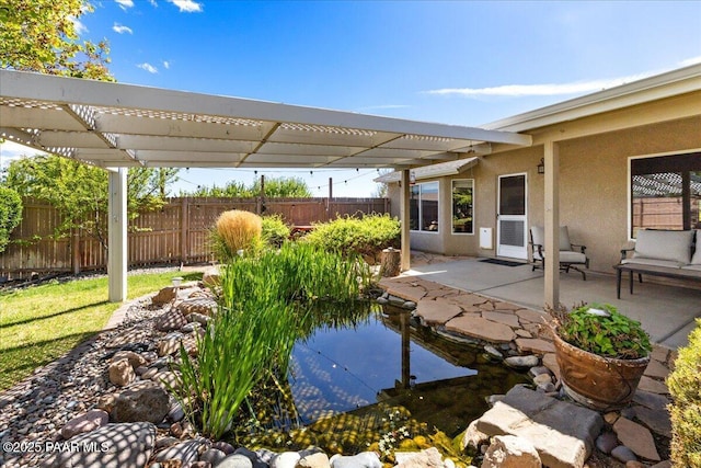 exterior space featuring a pergola, fence, and a patio