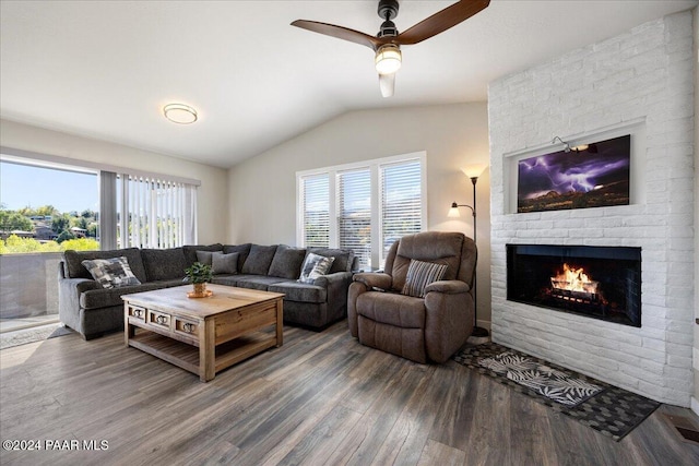 living room with a fireplace, hardwood / wood-style floors, vaulted ceiling, and ceiling fan