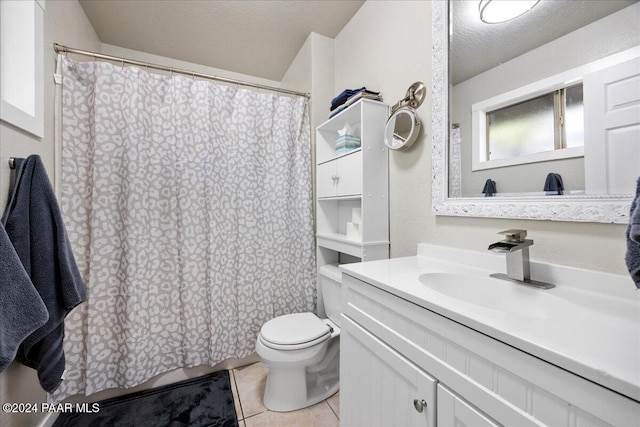 bathroom featuring tile patterned flooring, vanity, toilet, and a textured ceiling