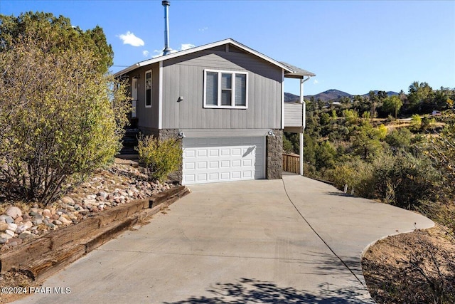 view of front facade featuring a mountain view and a garage