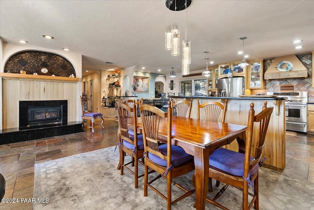 dining area featuring a tiled fireplace