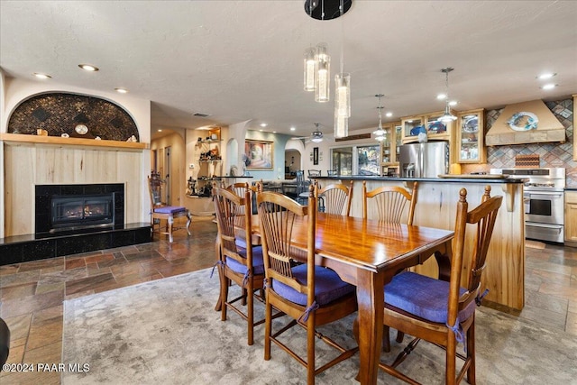 1568 W Thumb Butte Rd, Prescott, AZ 86305 - dining room with stone tile flooring, a tile fireplace, and recessed lighting