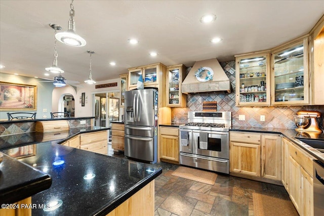 kitchen featuring backsplash, ceiling fan, decorative light fixtures, custom range hood, and stainless steel appliances