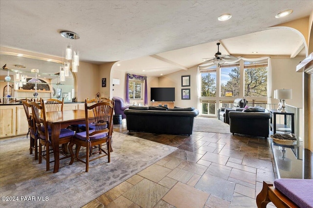 1568 W Thumb Butte Rd, Prescott, AZ 86305 - dining room featuring ceiling fan, stone tile flooring, vaulted ceiling, arched walkways, and recessed lighting