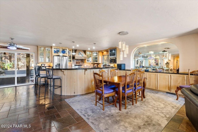 1568 W Thumb Butte Rd, Prescott, AZ 86305 - dining area featuring arched walkways, stone tile floors, a chandelier, a ceiling fan, and recessed lighting