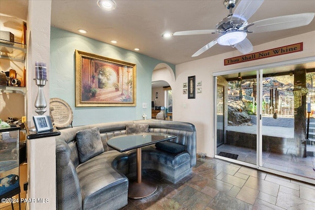 1568 W Thumb Butte Rd, Prescott, AZ 86305 - living room featuring arched walkways, ceiling fan, stone tile floors, recessed lighting, and plenty of natural light
