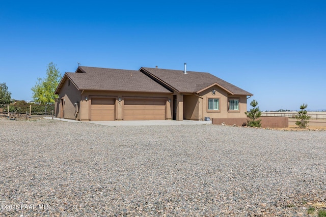8950 N Calico Cat Trl, Prescott Valley, AZ 86315 - view of front of property with stucco siding, a garage, and gravel driveway