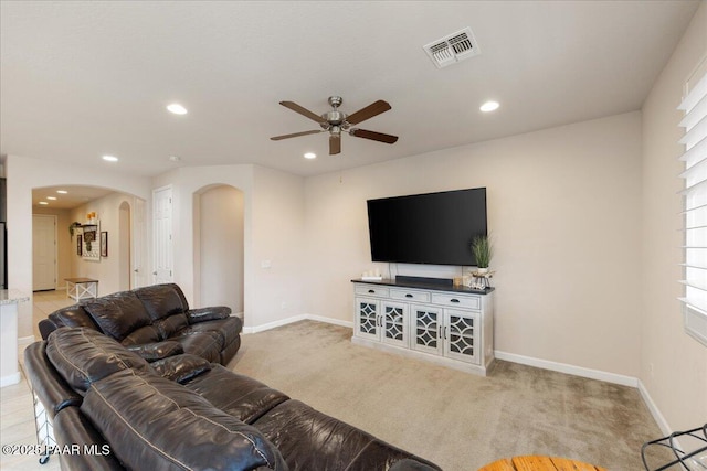 carpeted living room with ceiling fan and a healthy amount of sunlight