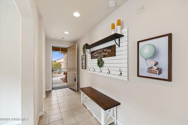 doorway to outside with light tile patterned floors