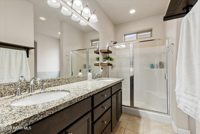 bathroom featuring tile patterned flooring, vanity, and a shower with shower door