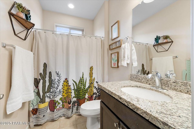 bathroom with vanity, tile patterned flooring, and toilet