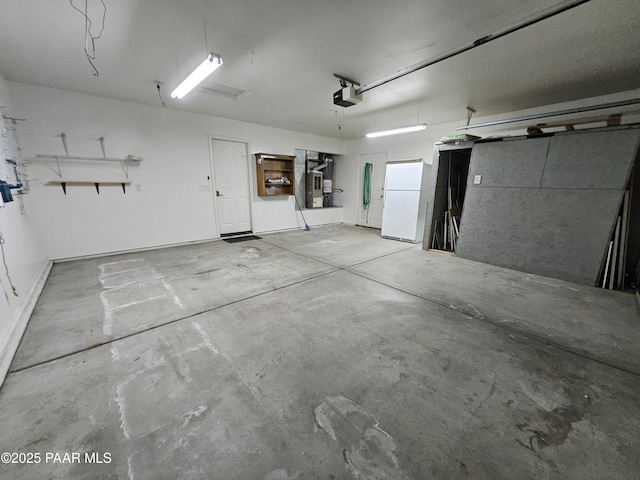 5050 N Saddleback Dr, Prescott Valley, AZ 86314 - garage with a garage door opener, freestanding refrigerator, and water heater