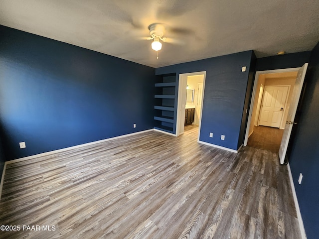 5050 N Saddleback Dr, Prescott Valley, AZ 86314 - unfurnished bedroom with wood finished floors, ensuite bath, and a ceiling fan