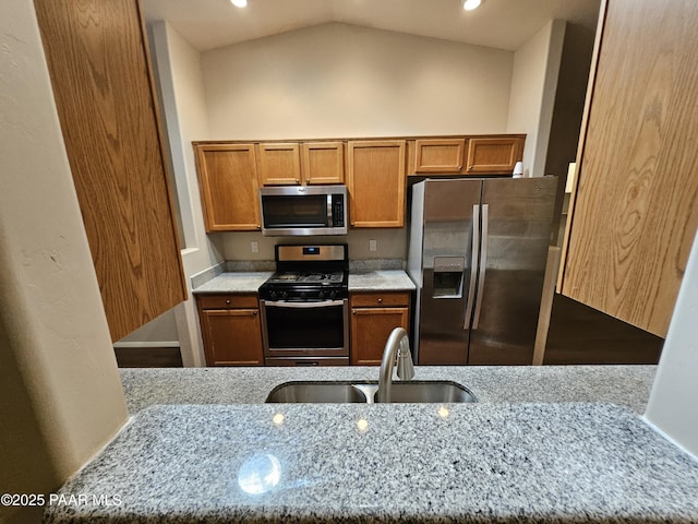 5050 N Saddleback Dr, Prescott Valley, AZ 86314 - kitchen with stainless steel appliances, light stone counters, brown cabinets, recessed lighting, and vaulted ceiling