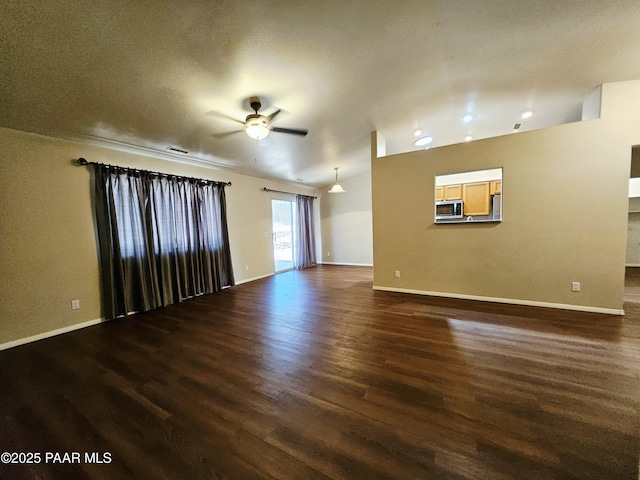 5050 N Saddleback Dr, Prescott Valley, AZ 86314 - unfurnished living room featuring a ceiling fan, dark wood finished floors, and recessed lighting