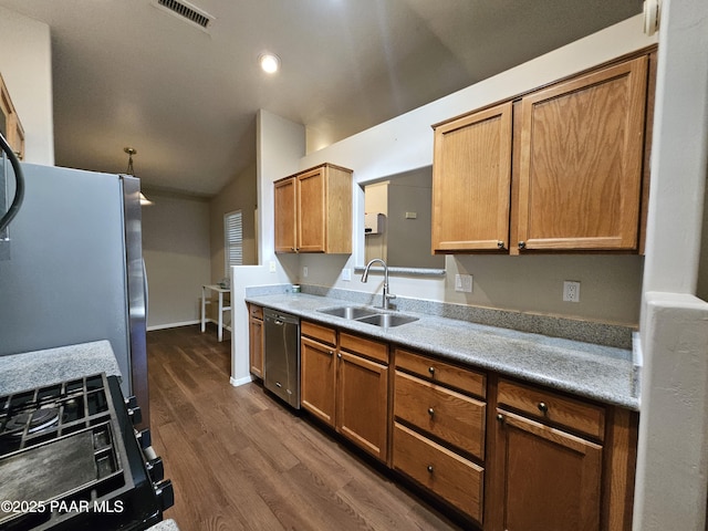 5050 N Saddleback Dr, Prescott Valley, AZ 86314 - kitchen featuring appliances with stainless steel finishes, dark wood-type flooring, vaulted ceiling, brown cabinets, and light countertops