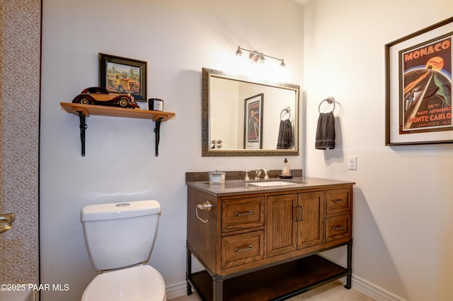 bathroom featuring toilet and vanity