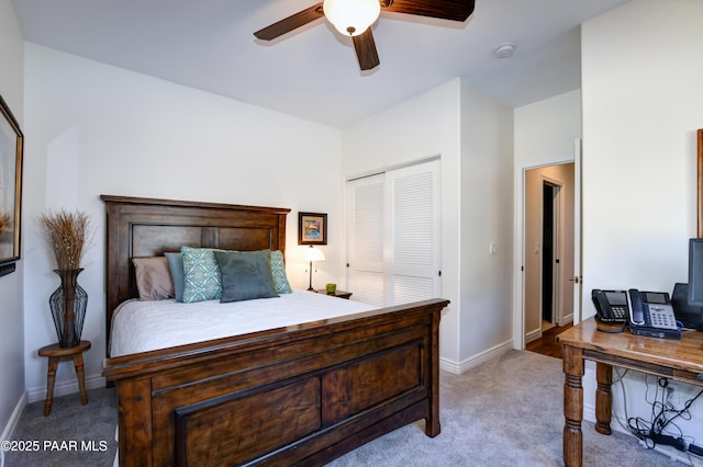 carpeted bedroom featuring ceiling fan and a closet