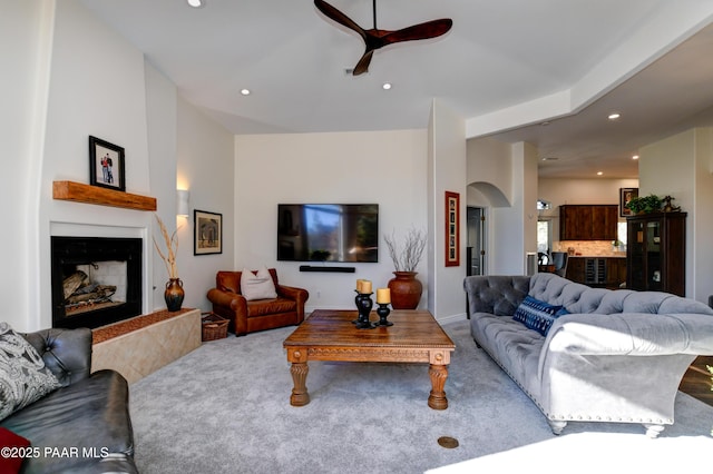 carpeted living room featuring ceiling fan