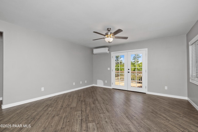 spare room with ceiling fan, dark hardwood / wood-style flooring, french doors, and a wall unit AC