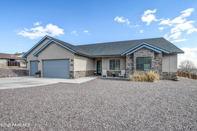 single story home with stucco siding, a shingled roof, a garage, stone siding, and driveway