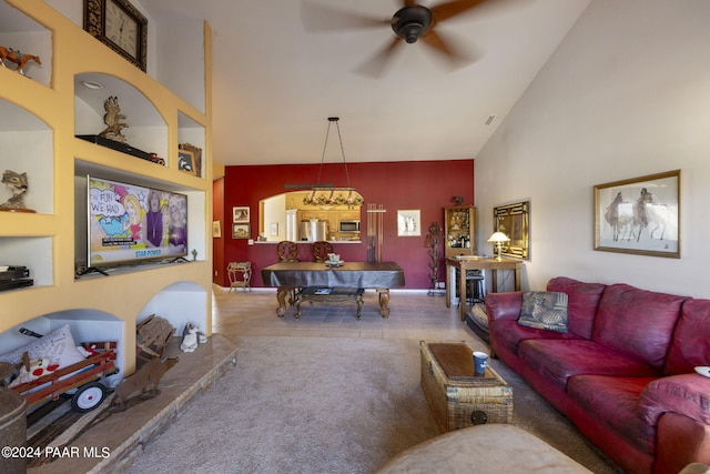 living room featuring ceiling fan and a high ceiling