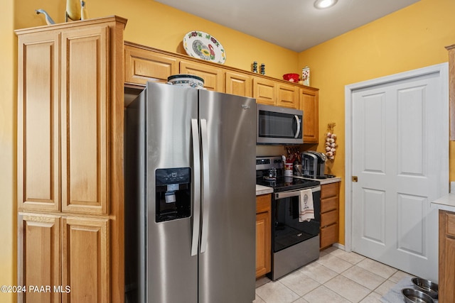 kitchen featuring light tile patterned floors and appliances with stainless steel finishes