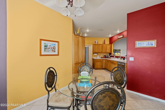 dining space with light tile patterned floors and sink