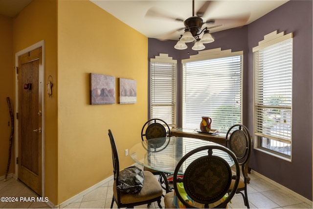 tiled dining area with ceiling fan and a wealth of natural light