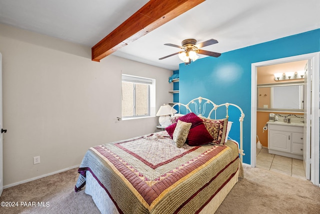 bedroom featuring connected bathroom, beamed ceiling, sink, ceiling fan, and light colored carpet