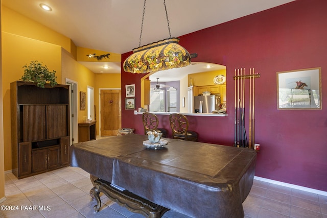 tiled dining space with billiards and vaulted ceiling