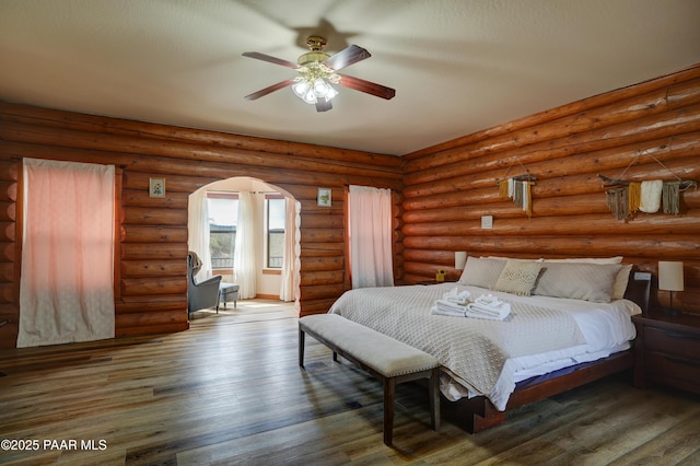 1070 Quiet Pines Ln, Prescott, AZ 86303 - bedroom with wood finished floors, arched walkways, and a ceiling fan
